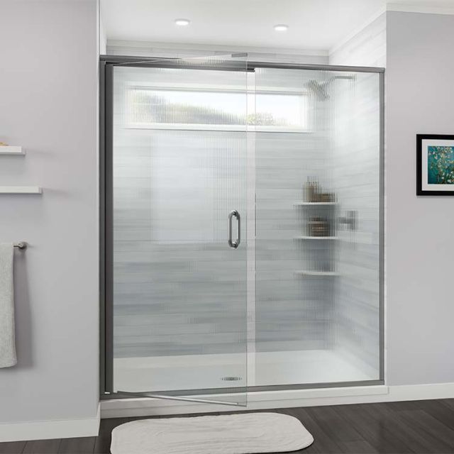 Pivoting shower door with fluted privacy glass and antique pewter hardware
